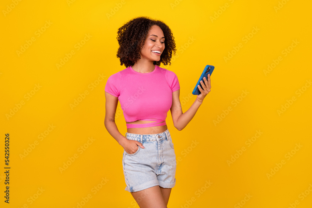 Portrait of gorgeous positive person hold use telephone chatting isolated on yellow color background Portrait of gorgeous positive person hold use telephone chatting isolated on yellow color background