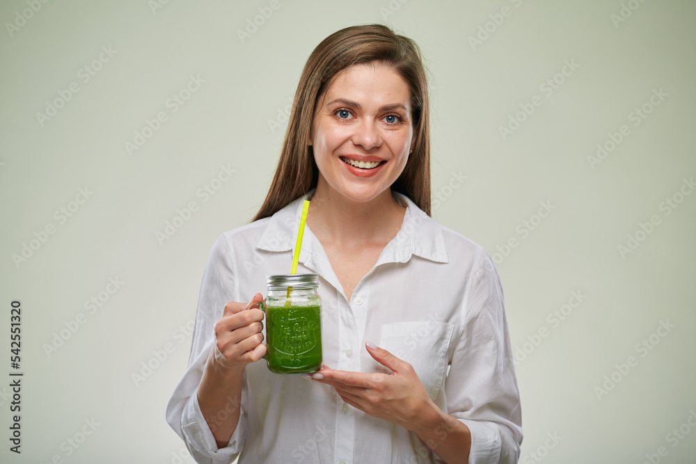 Smiling woman holding green smoothie. Isolated female advertising portrait. Smiling woman holding green smoothie. Isolated female advertising portrait.