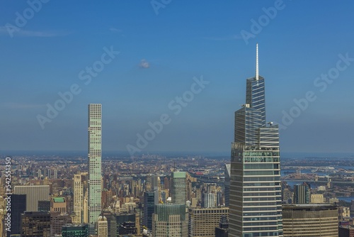 Beautiful view of densely built-up Manhattan on blue sky background. USA. 