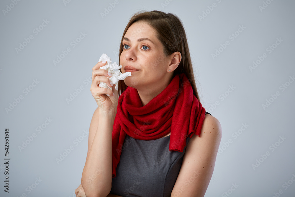 Sick business woman wearing red scarf using tissue for her nose, isolated advertising portrait. Sick business woman wearing red scarf using tissue for her nose, isolated advertising portrait.