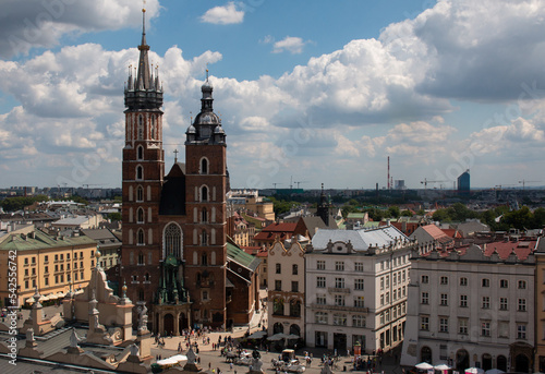 Krakow, Poland, July the 15th 2022. The crowded central market square of Krakow with St Mary's Basilica by the side of it.