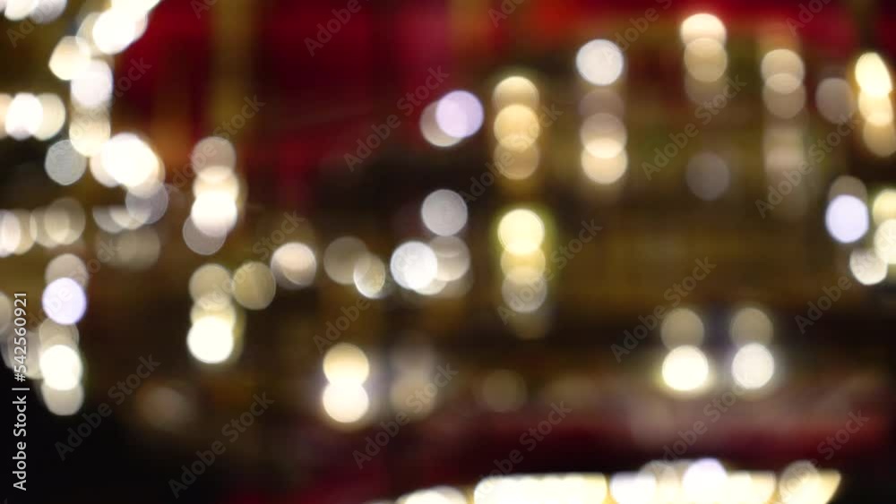 Golden illuminated defocused retro carousel spinning in an amusement park. Blurred shiny carousel glowing and spinning at night. spinning symbol of childhood. festival atmosphere of the fair.