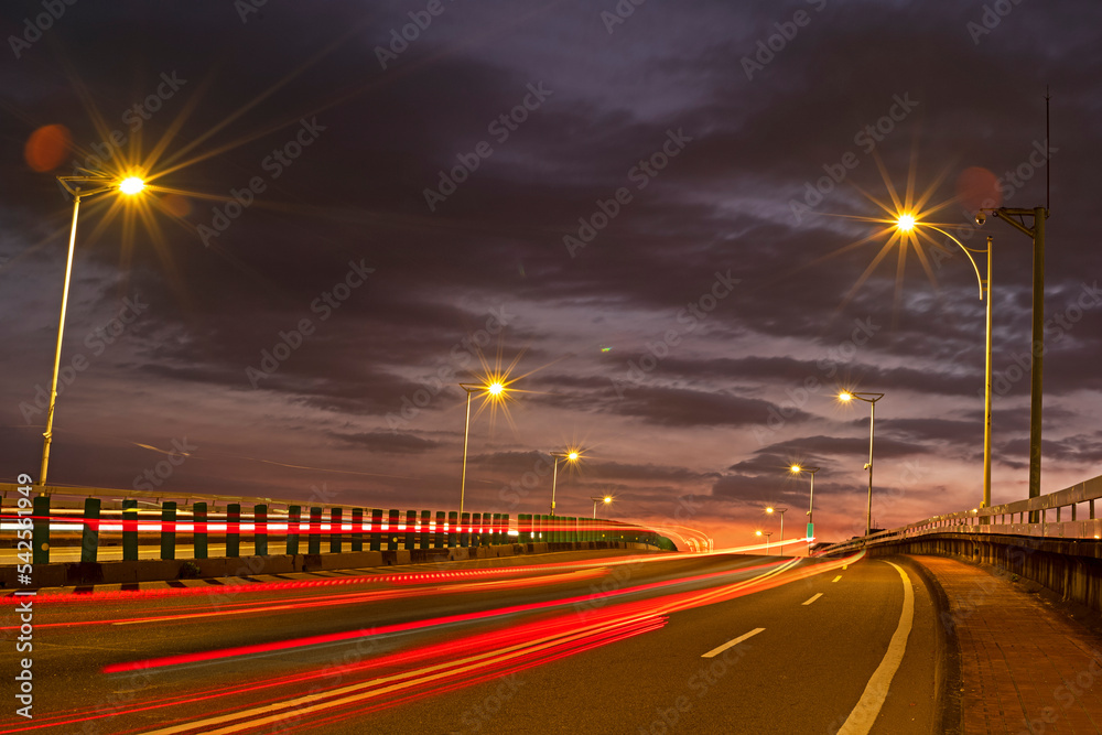 Car light trails on Minquan bridge at sunrise    