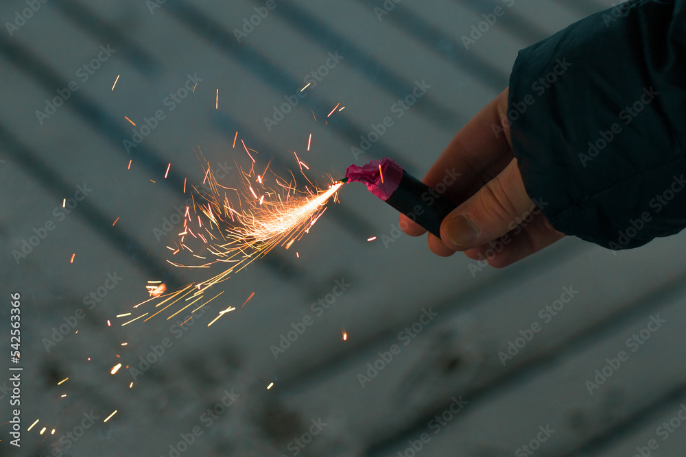 Burning Firecracker with Sparks. Guy Holding a Petard in a Hand. Loud