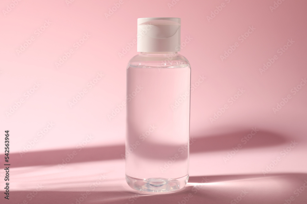 Bottle of micellar water on pink background Bottle of micellar water on pink background