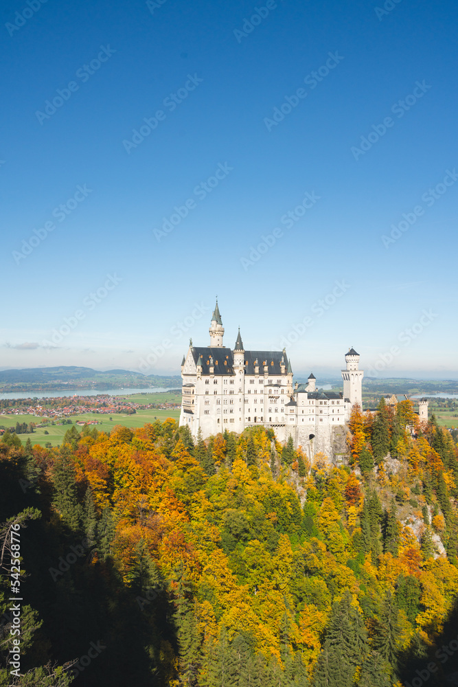stunning white castle on the hill in autumn with vibrant fall colors