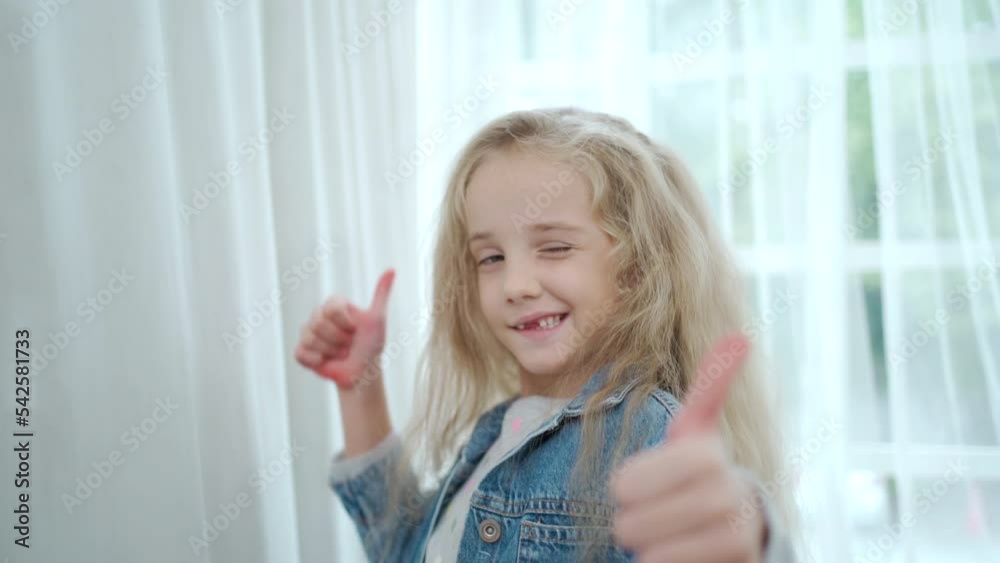 Happy caucasian girl smiling and showing thumb up to camera. Happy caucasian girl smiling and showing thumb up to camera.