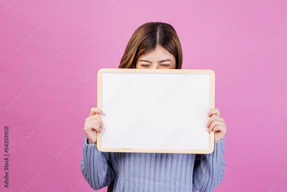 Portrait of Happy young woman holding an empty white placard over isolated pink background. Portrait of Happy young woman holding an empty white placard over isolated pink background.