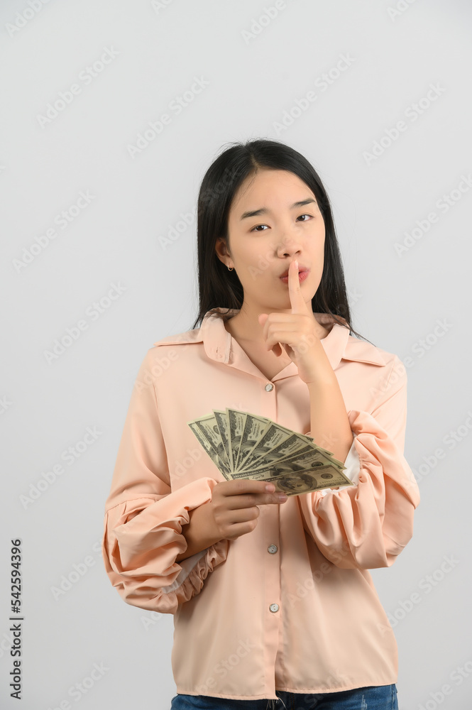 Portrait of a cheerful young woman holding money banknotes and celebrating isolated over white background Portrait of a cheerful young woman holding money banknotes and celebrating isolated over white background