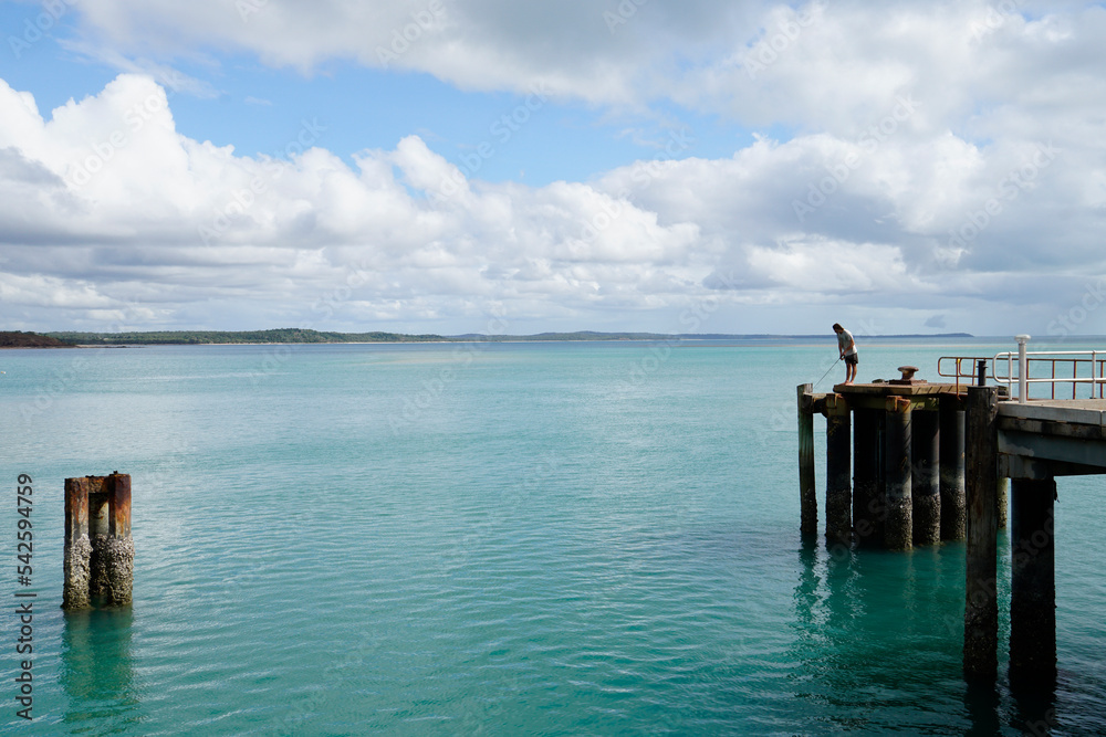 man fishing on the jetty at Seisia North Queensland man fishing on the jetty at Seisia North Queensland