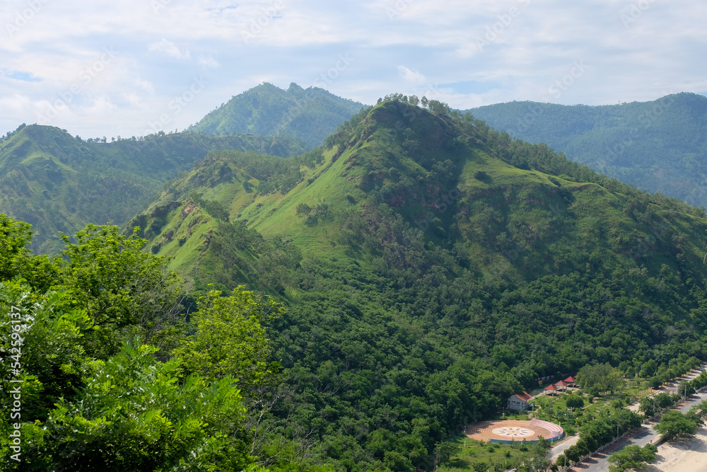 Tree covered green hilly, mountainous landscape during wet season on the tropical island of Timor Leste in Southeast Asia