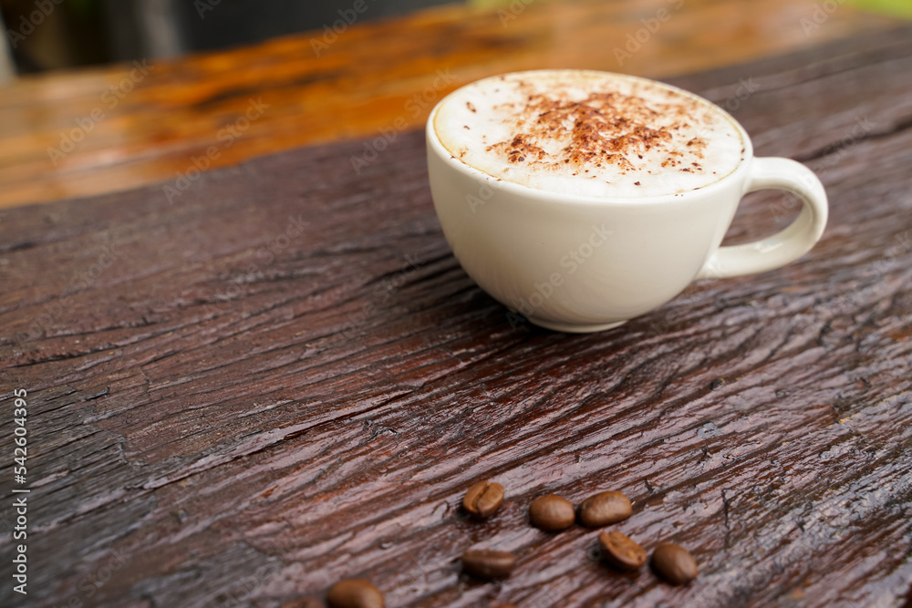 Hot cappuccino in white cup with wooden background,coffee is a popular drink all over the world. Hot cappuccino in white cup with wooden background,coffee is a popular drink all over the world.