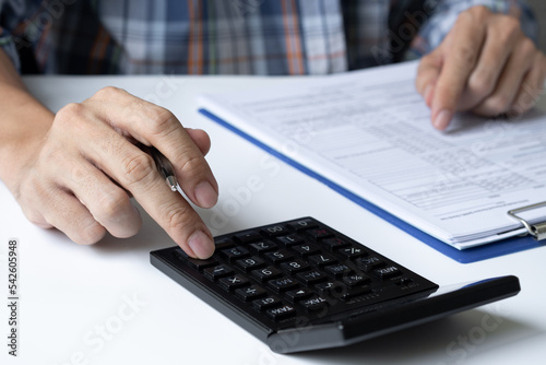 close up. business man working on his desk using a calculator to calculate numbers financial accounting concept.