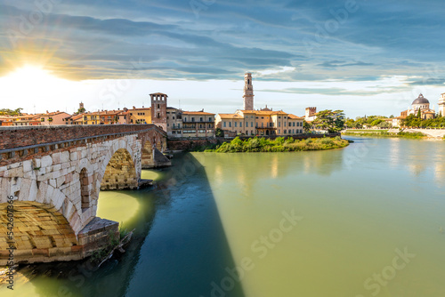 Sunset view of the Ponte Pietra bridge over the Adige River with the Torre dei Lamberti Tower rising above the old town in Verona, Italy.  © Kirk Fisher