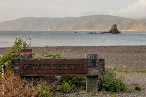 Oruaiti Reserve entrance sign on edge of beach
