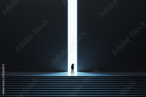 Business success and opportunity concept with pensive woman in front of bright light hole in the middle of wall in a dark huge dark hall with stairs