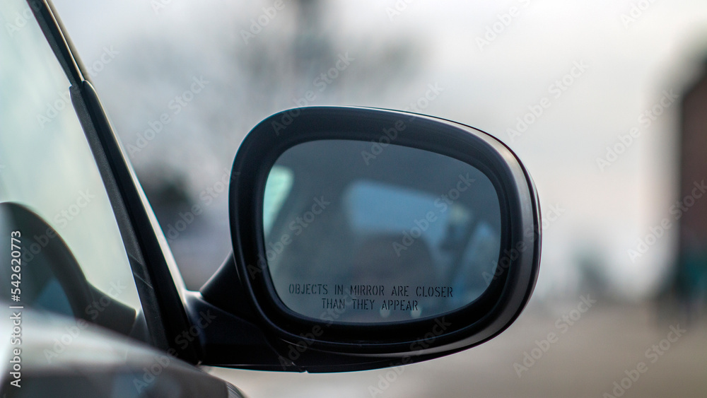 Rear view mirror on a black car