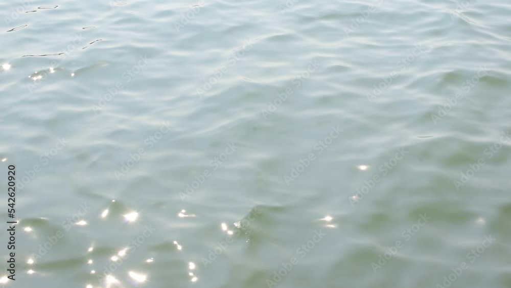 The sea surface ripples with shadows, sunlight, glitters, abstract. The sea surface ripples with shadows, sunlight, glitters, abstract.