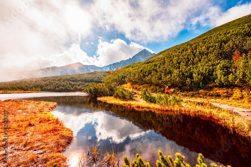 Hiking in national park High Tatras. HiIking to biele pleso near zelene pleso in the mountain Vysoke Tatry, Slovakia photo