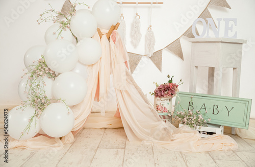 pink and white decoration for a 1st birthday cake smash studio photo shoot with balloons, paper decor, cake and topper. High quality photo