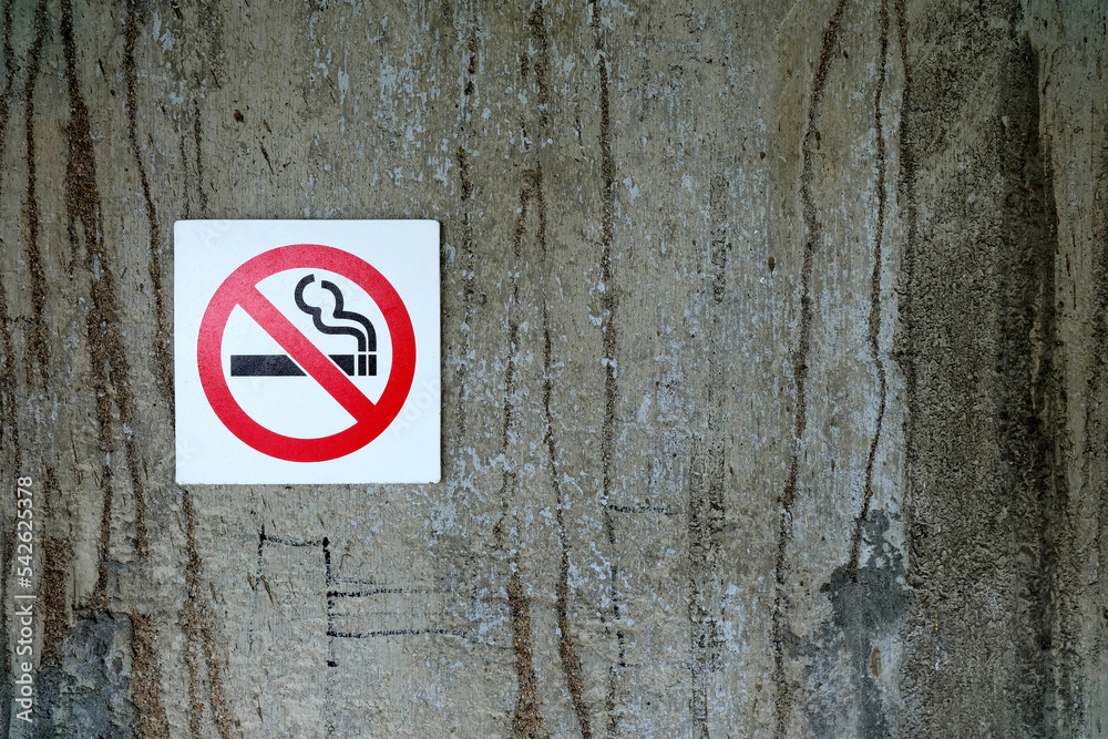 No Smoking Sign on Grunge Concrete Wall Texture Background. No Smoking Sign on Grunge Concrete Wall Texture Background.