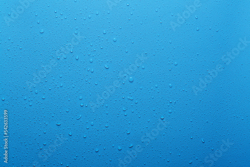 Water drops on blue background and texture