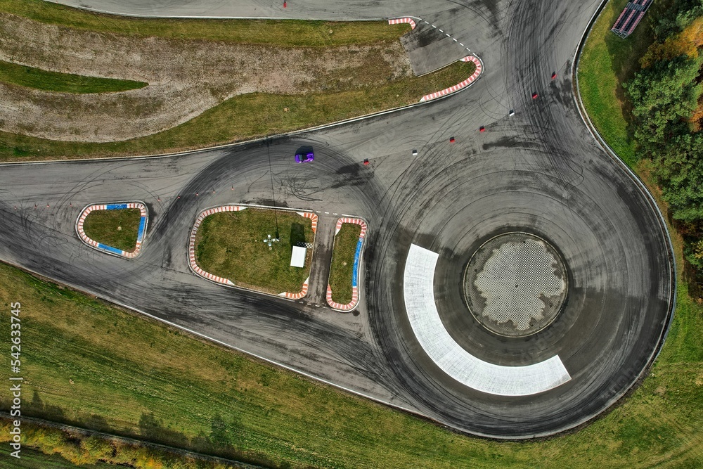 car racing track and racing cars as seen from above from a drone. Fast, luxury cars.