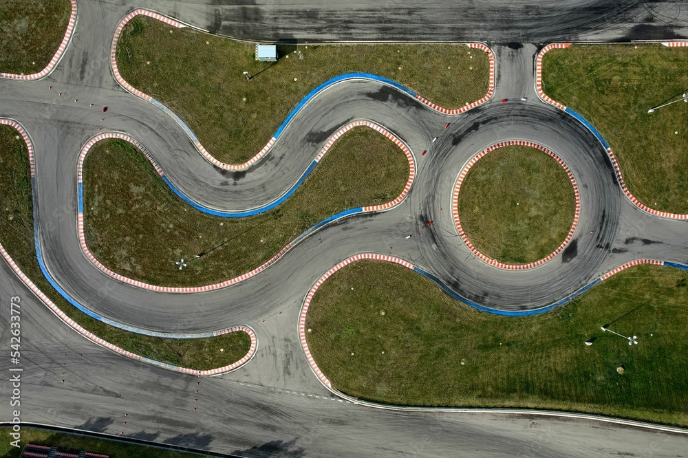 car racing track and racing cars as seen from above from a drone. Fast, luxury cars.