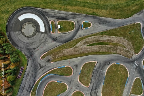 Obraz na płótnie car racing track and racing cars as seen from above from a drone. Fast, luxury cars. w salonie