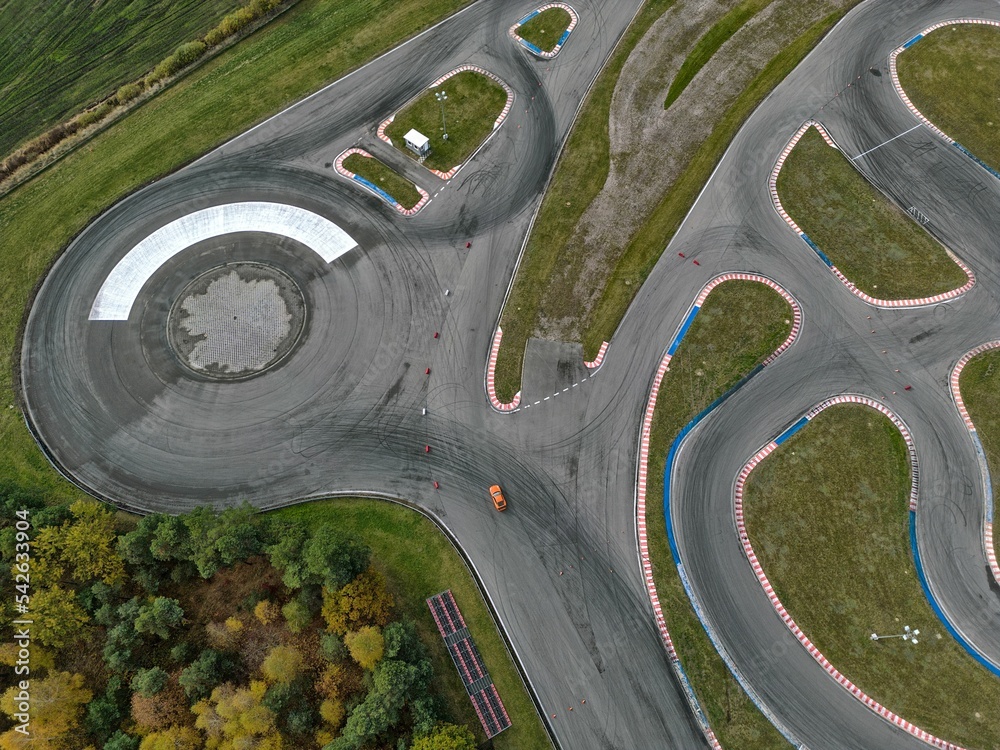 car racing track and racing cars as seen from above from a drone. Fast, luxury cars.