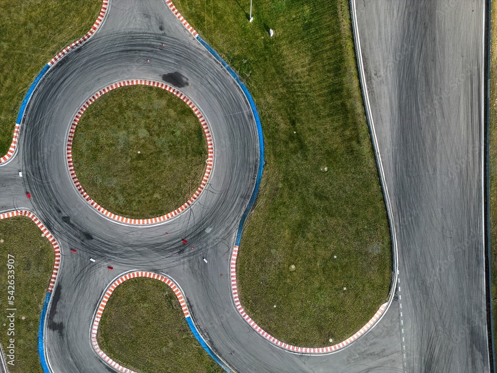 car racing track and racing cars as seen from above from a drone. Fast, luxury cars.