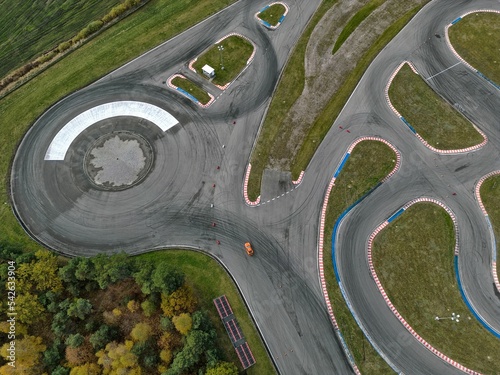 Obraz na płótnie car racing track and racing cars as seen from above from a drone. Fast, luxury cars. w salonie