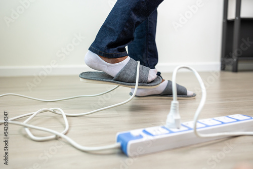 A man stumbles upon a cluttered wire lying on the ground. Stumbled until the head hit the ground. Accident at home It is because of carelessness and clumsiness electric shock photo