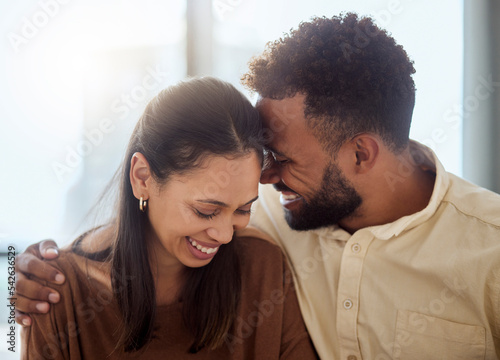 Couple, black people and love hug of a girlfriend and boyfriend with a smile together. Anniversary of happiness of a woman and man in a home laughing at a funny joke with happy bonding and affection