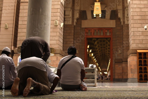 Muslims praying inside Nabawi Mosque. Interior view of Masjidil Nabawi (Nabawi Mosque) in Medina.