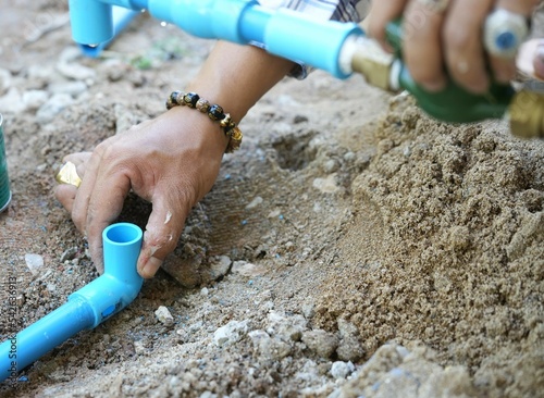 right hand holding the pipe of skilled technicians