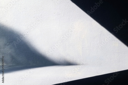 White Light Beam and Shadow on Gurnge Concrete Wall Background, Suitable for Product Presentation Backdrop, Display, and Mock up. photo