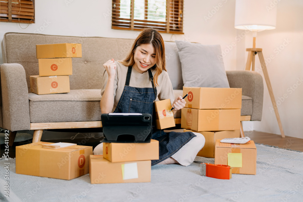 Small business entrepreneur SME freelance woman working at home office, BOX,tablet and laptop online, marketing, packaging, delivery, concept. Small business entrepreneur SME freelance woman working at home office, BOX,tablet and laptop online, marketing, packaging, delivery, concept.