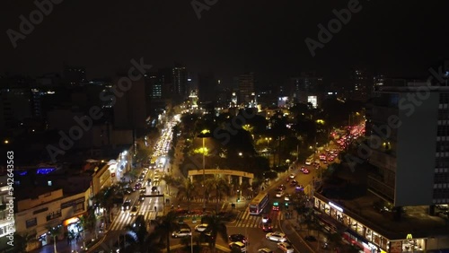 Wallpaper Mural Drone 4k aerial video of night time Lima Peru, of "Kennedy Park" in the Miraflores district. Drone flies slowly forward. Many cars in the street with their headlights on. Torontodigital.ca
