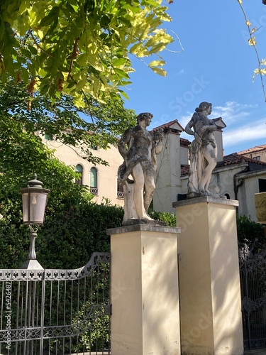 Old statues in the hidden gardens of Ca rezzonico in Venice, Italy