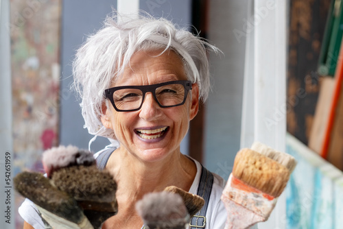 Принти на полотні smiling happy older woman portrait, proud artist, in her fifties with grey hair
