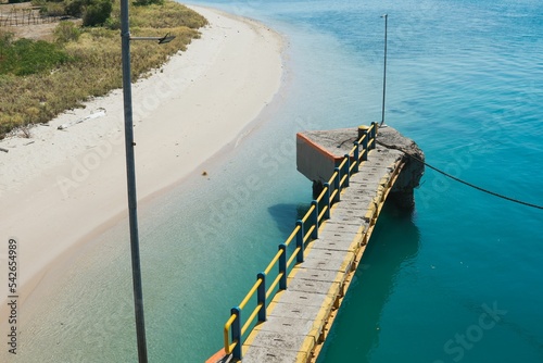 Aerial view of a wooden boardwalk entrance in the sea, Poto Tano Harbour, Sumbawa, Indonesia photo