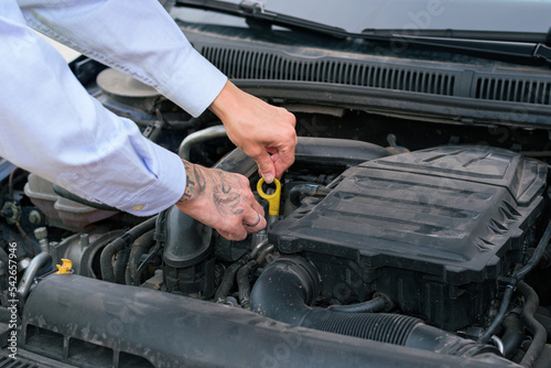 Close-up of a man looking on a car hood