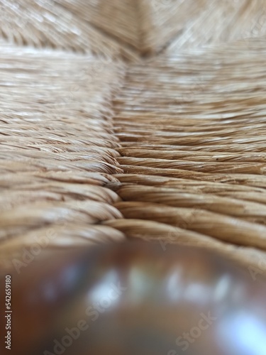 Textured woven straw background in a chair seat photo