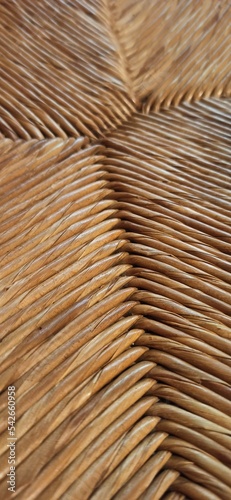 Textured woven straw background in a chair seat photo