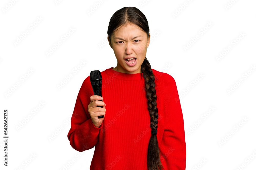 Young Chinese singer woman isolated screaming very angry and aggressive. Young Chinese singer woman isolated screaming very angry and aggressive.