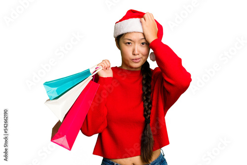 Young asian woman shopping a christmas presents isolated Young asian woman shopping a christmas presents isolated being shocked, she has remembered important meeting.