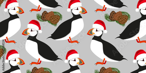 Atlantic Puffin Merry Christmas New Year Card. North fauna, wildlife. Red Book bird in Christmas Hat. Christmas Puffin on Grey Background. Website Merry Christmas, Background or Banner 