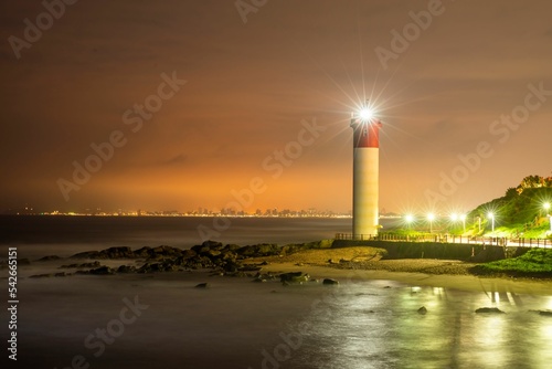 Beautiful shot of a lighthouse at Durban Beach at night