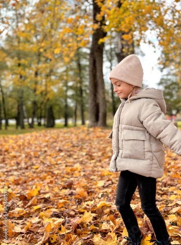 girl running in the yellow leaves in autumn park.  © Julija